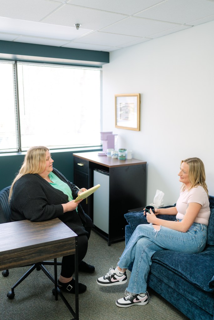 Therapist meeting with a client in a comfortable office setting